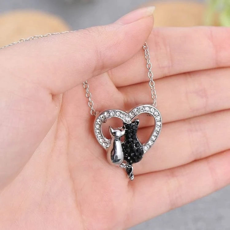 Heart shaped black and white cats necklace